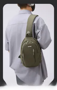 Detail showing military green nylon crossbody bag with adjustable wide strap and zipper pockets