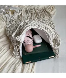 Spacious interior of white crochet tassel bag showing capacity for a tablet and umbrella