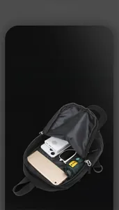 Detail view of large capacity black sling bag showing smart storage for tablet and umbrella