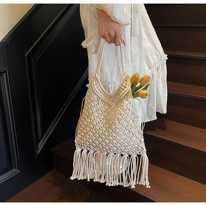 Detail of bohemian hand-woven cotton tote bag featuring long fringe and hollow mesh design