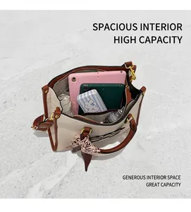 Detail view of large capacity tote bag interior with multiple everyday items stored inside