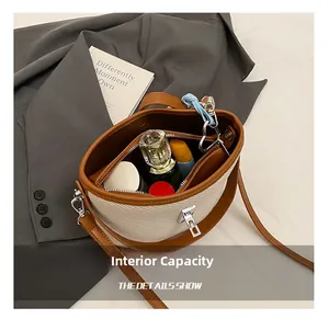 Interior view of beige woven bucket bag showing lipstick and perfume storage detail