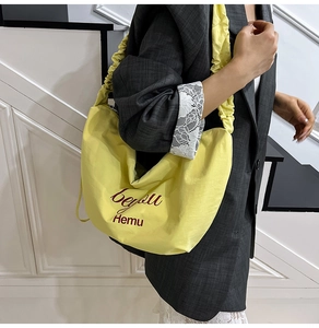 Fashionable yellow moon-shaped hobo bag with unique pleated cloud strap for daily commute