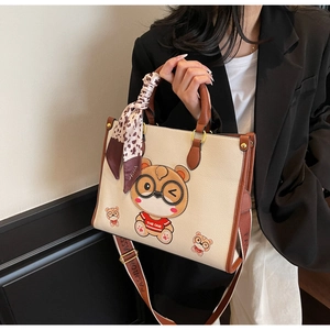 Detail of cream bear tote bag with leopard scarf and adjustable fashion shoulder strap