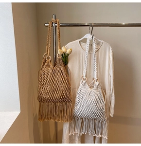 Detailed knit pattern and long tassels of bohemian woven bucket bags with wooden handles