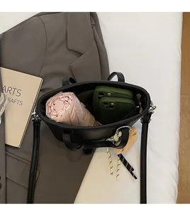 Top view of black pebbled leather bucket bag showing spacious interior with umbrella and phone