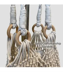 Close-up of Macrame woven bag details with natural wooden ring handle and cotton knots