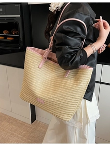 Minimalist straw tote bag with pink leather handles and branded patch for beach travel