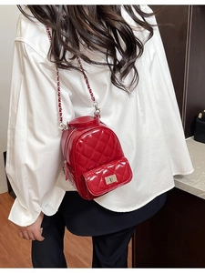 Quilted red glossy mini crossbody bag with metal chain strap and turn-lock closure