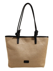Minimalist straw tote bag with black leather straps and refined woven texture on white background