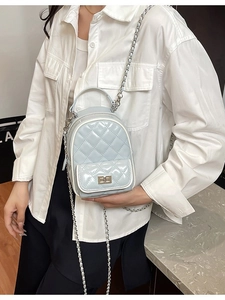 Quilted light blue patent leather mini backpack with metal chain straps and turn-lock