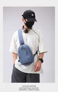 Blue crossbody chest bag with multi-layer zippers and textured nylon fabric on model