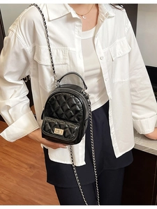 Chic black quilted mini backpack with silver chain strap and metal turn-lock closure