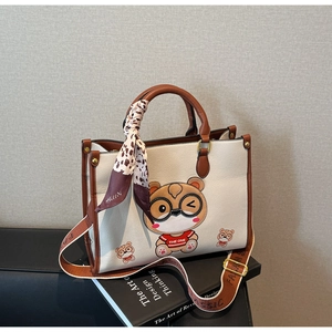 Detail of cute bear tote bag with leopard silk scarf and branded fashion shoulder strap