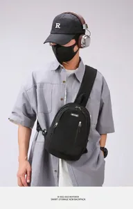 Detail of durable black nylon crossbody chest bag with adjustable strap and zip pockets