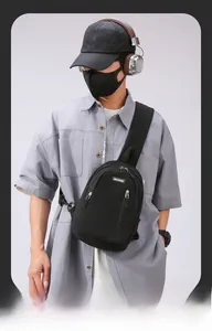 Detail of durable black nylon crossbody chest bag with adjustable strap and zip pockets