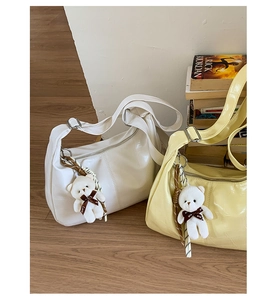 Detail of crocodile pattern PU leather shoulder bags with cute plush bear charms