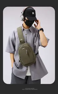 Detail of army green crossbody bag with adjustable wide shoulder strap and front zipper pocket