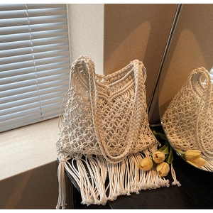 Close-up of Macrame woven tote bag with long fringe and inner cloth pouch for seaside vacation
