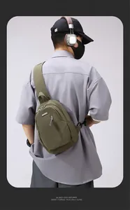 Detail of army green waterproof nylon chest bag featuring a functional front zipper pocket