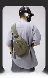 Detail of army green waterproof nylon chest bag featuring a functional front zipper pocket