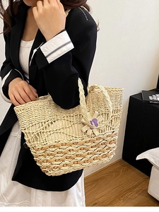 Large woven straw tote bag in light beige with purple floral charm for beach vacation