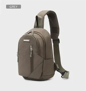 Detailed side view of grey crossbody bag with multiple zippers and wide strap