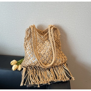 Detail of bohemian hand-woven tote bag with fringe tassels and a secure inner liner