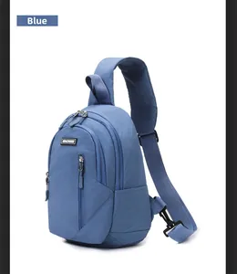 Detail view of a blue waterproof chest bag featuring multiple zipper compartments and buckles