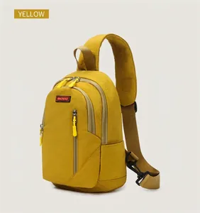 Detail view of yellow nylon chest bag with scratch-resistant texture and khaki strap