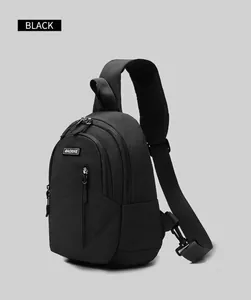 Detail view of black nylon chest bag with triple zip compartments and adjustable strap