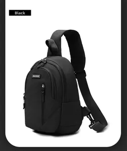 Detail view of black nylon chest bag with triple zip compartments and adjustable strap