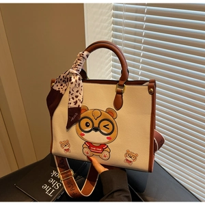 Detail of cute bear tote bag with leopard print scarf and fashionable wide strap