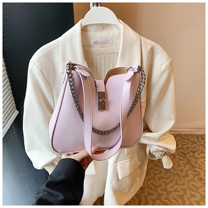 Detail of lavender bucket bag with silver twist lock and decorative chain strap