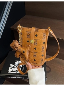 Brown vintage bear pattern crossbody bag with leather strap and golden charm pendant