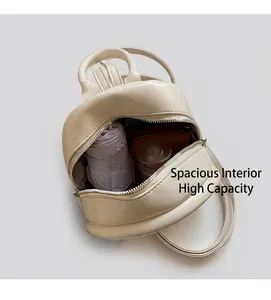 Detailed interior of a white quilted mini backpack showing umbrella and wallet storage