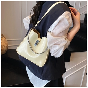 Chic cream leather bucket bag with silver metal chain detail and rectangular twist lock