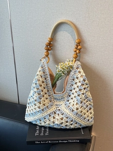 Handwoven summer straw tote bag with blue diamond pattern and round wooden bead handles