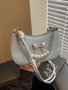 Blue denim crescent bag with metallic bow, pearl chain and silver rope strap detail