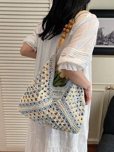 Blue and beige hollow crochet tote bag with wooden bead straps for summer beach style