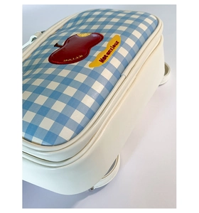 Detailed view of blue checkered tote with apple embroidery and Not Anxious label