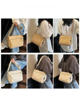 Detailed views of high-capacity canvas crossbody bag in beige and khaki colors