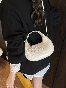 Cream crescent shoulder bag with pleated leather, pearl heart charm and metal accents
