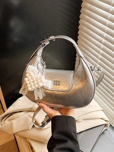 Silver metallic dumpling handbag with heart pearl charm and pleated texture