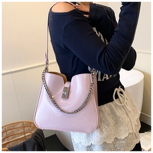 Detail of pink patent leather bucket bag with silver chain and metal buckle