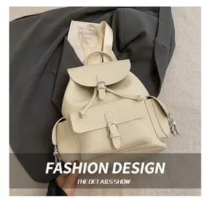 Detail of cream leather backpack featuring magnetic buckle and textured pebbled surface