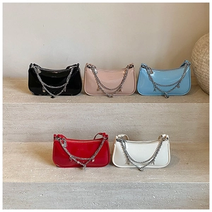 Five glossy patent leather crossbody bags in various colors with double metal chains