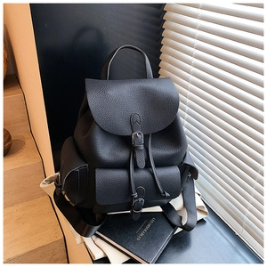 Detail of black lychee grain backpack featuring a metal buckle and high-quality PU texture
