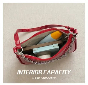 Internal view of a red patent leather crossbody bag showing its storage capacity