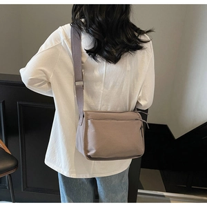 Detail view of khaki canvas crossbody bag with adjustable wide strap for daily use